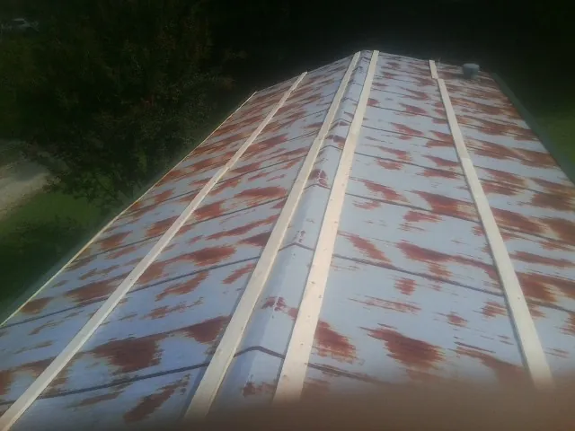 Rusted metal roof panels with new wood purlins before replacement — Storm Damage Roof Repair in Atherton by Roofing Brothers