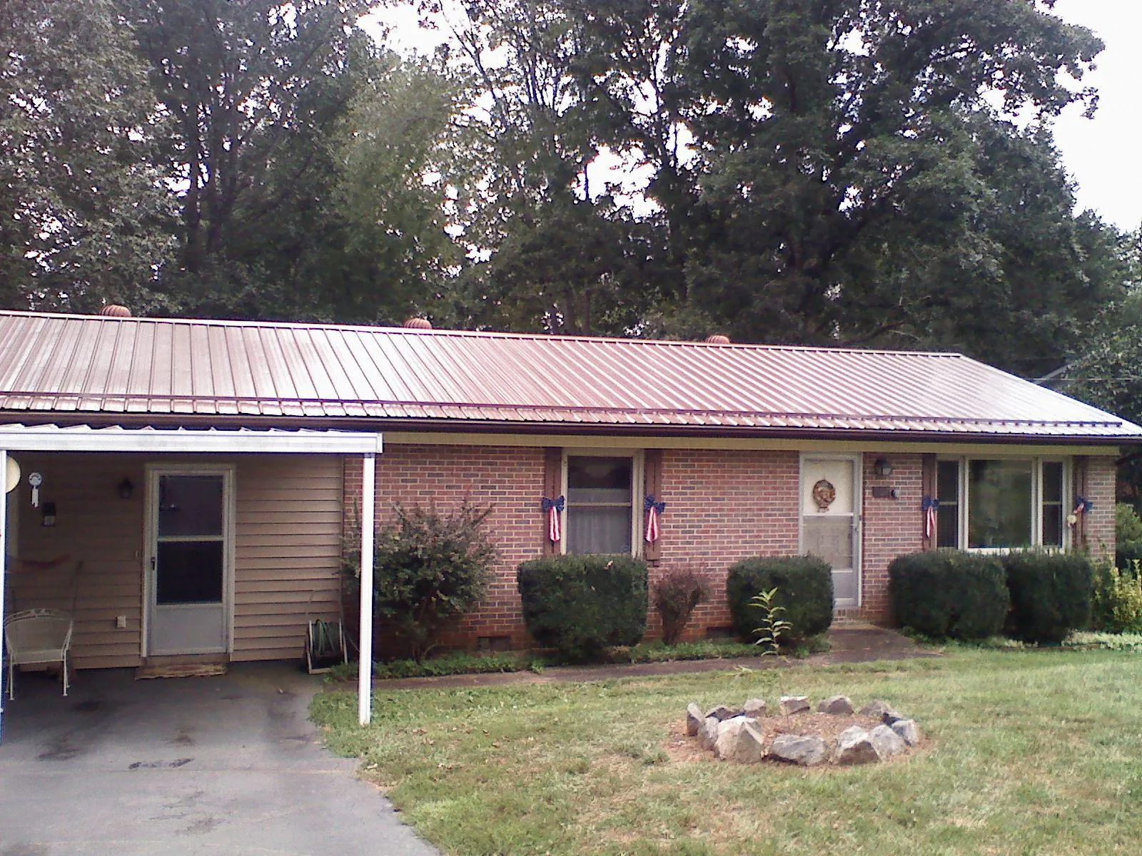 Bronze metal roof and carport on a brick ranch home — Roof Repair work by our crew in Atherton